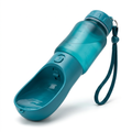 Teal portable dog water bottle with integrated drinking trough on a white background